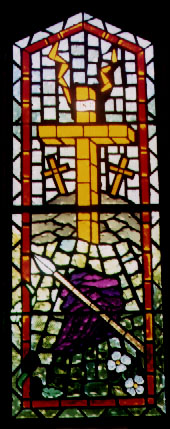 A stained glass window depicting the crucifixion from the Apostle's Creed.